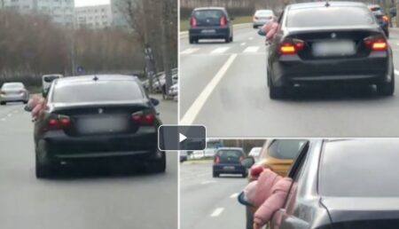 Imagini revoltătoare! Copil filmat atârnând pe geamul deschis al unui BMW